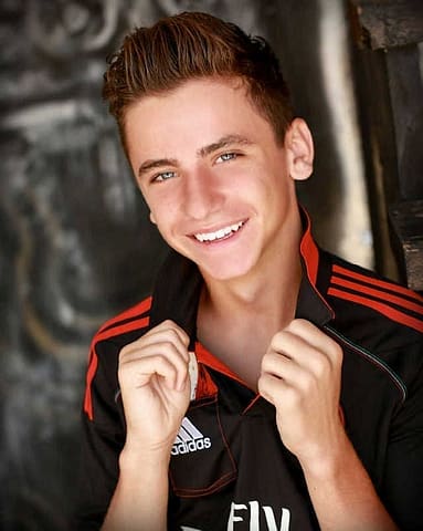 School Senior Portrait: Grad Grabbing Collar Looking Cool